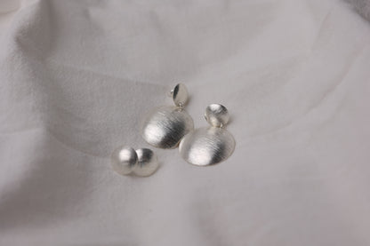 Minimalist Handcrafted Frosted Silver Ear Stud — round studs shown beside matching drop earrings