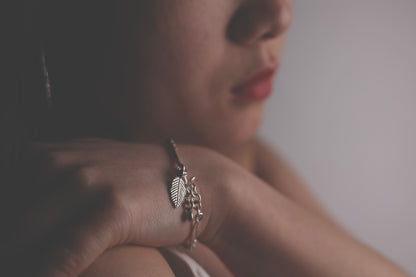 The Leaf Set — model wearing leaf-pendant bracelet