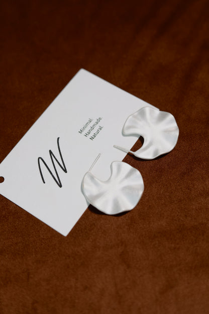 The Windmill-Earrings — close-up of windmill-shaped earrings and card