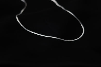 Handcrafted Minimalist Basic Silver Chain Necklace — smooth chain necklace arranged on black fabric
