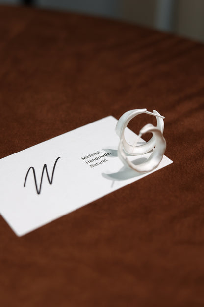 The Leaves-Earrings — leaf hoops displayed on branded card