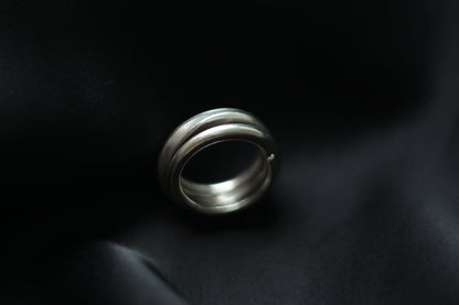 Handcrafted Silver Ring-The Loop — layered loop band on black fabric