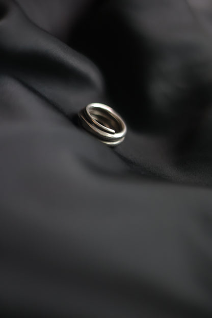 Handcrafted Silver Ring-The Loop — side view of loop band on black fabric