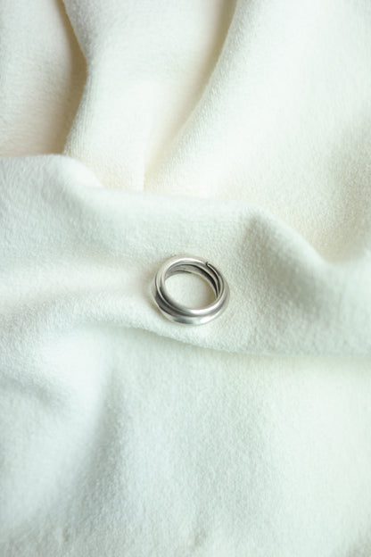 Handcrafted Silver Ring-The Loop — top view on pale fabric