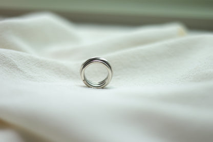 Handcrafted Silver Ring-The Loop — upright loop band on pale fabric