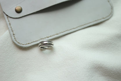 Handcrafted Silver Ring-The Loop — loop band beside a grey case