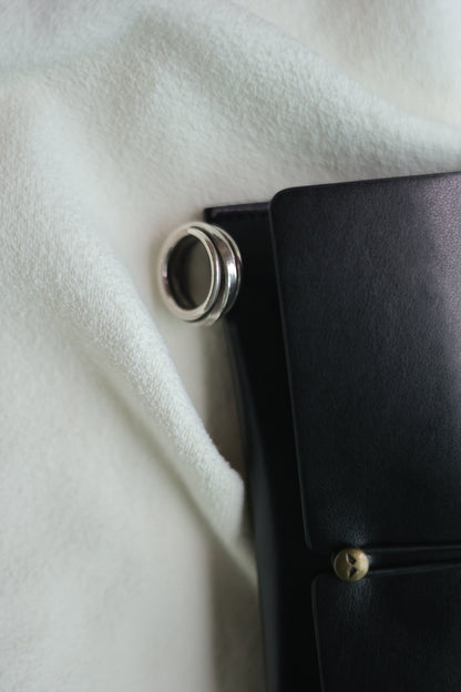 Handcrafted Silver Ring-The Loop — loop band beside a black case