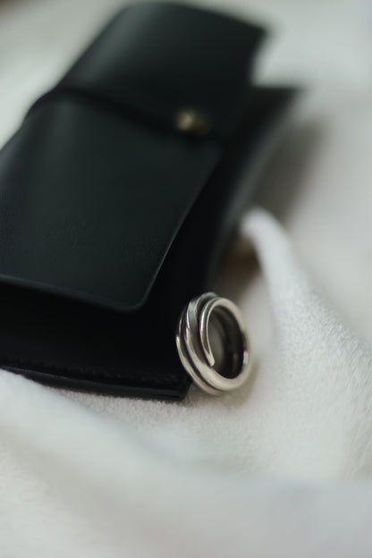 Handcrafted Silver Ring-The Loop — loop band beside a black case