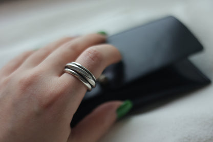 Handcrafted Silver Ring-The Loop — loop band worn beside a black case