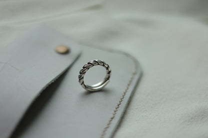 Handcrafted Braided Silver Ring-Unisex — braided band beside a grey case