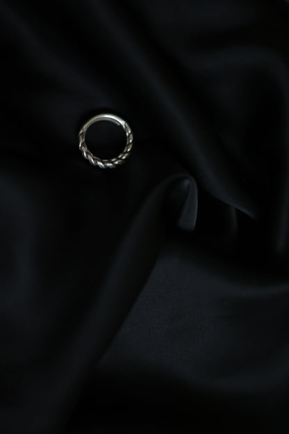 Handcrafted Braided Silver Ring-Unisex — top view of braided band on black fabric