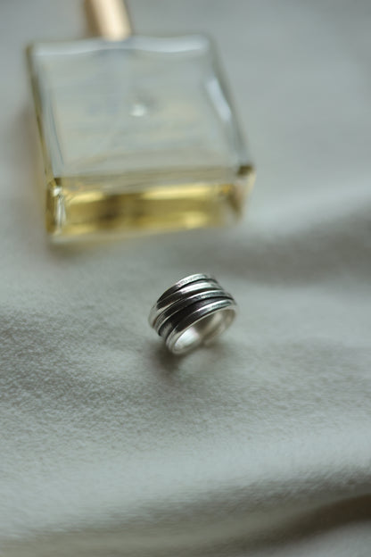 Handcrafted Silver Ring-Unisex — band beside a perfume bottle