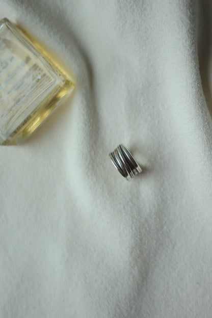 Handcrafted Silver Ring-Unisex — band on pale fabric beside a perfume bottle