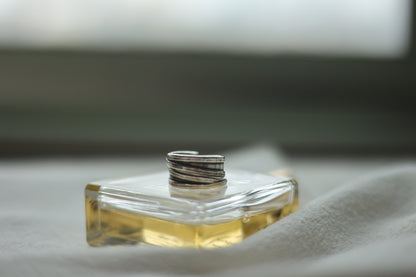 Handcrafted Silver Ring-Unisex — ridged band resting on a perfume bottle