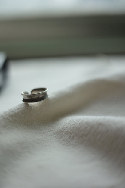 Minimalist Handmade Silver Ring — band on pale fabric