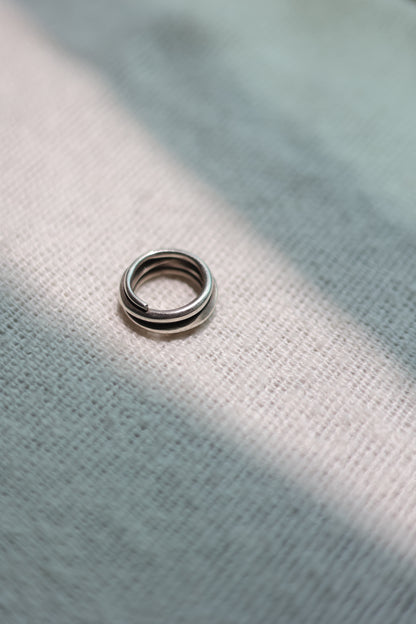 Handcrafted Silver Ring-The Loop — top view of loop band on pale fabric