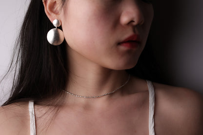 The Minimal Statement Set — model wearing round drop earrings with beaded necklace