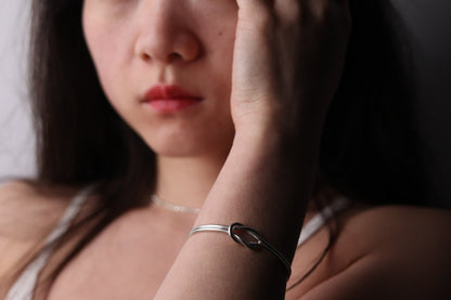Handcrafted Minimal Style Silver Bangle-The Knot — knot bangle worn on a wrist