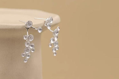 The Stars-Earrings — silver-tone star earrings on a plate rim
