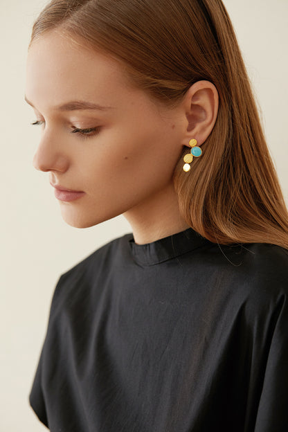 The Stones-Earrings — side view of gold-tone drop earring worn on an ear