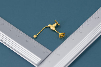 The Tab- Earrings — gold-tone tap-shaped earring photographed beside a ruler
