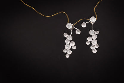 The Stars-Earrings — silver-tone star earrings hanging from a thread