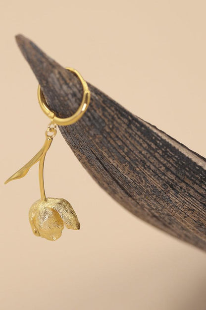 The Tulips-Earrings — gold-tone tulip earring hanging from a leaf