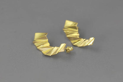 The Origami-Earrings — close-up of gold-tone folded earrings
