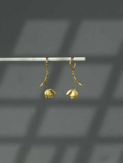 The Tulips-Earrings — gold-tone tulip earrings hanging from a bar
