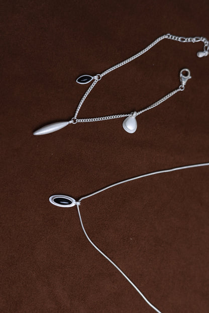 The Onyx Set- Necklace & Bracelet — close-up of necklace and bracelet pendants