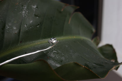 Magnolia Flower Hair Pin — magnolia-shaped hair pin on green foliage