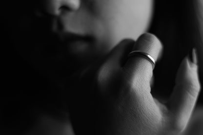 Handcrafted Minimalist Basic Silver Ring — smooth band worn in a black-and-white portrait