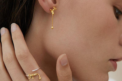 The Tab- Earrings — gold-tone tap-shaped earring worn with matching ring