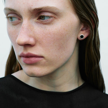The B & R Agate Ear Stud — black round ear stud worn on an ear