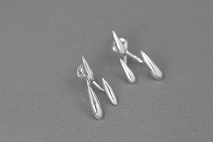 Rain Drops Earrings — pair of silver-tone drop earrings on grey surface