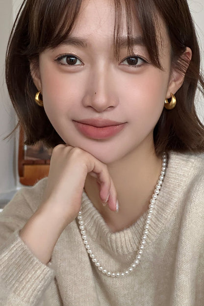 The Minimalist Basic Hoop - The Drop — model wearing gold-tone rounded hoops