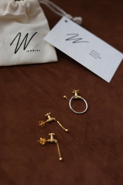 The Tab-Handcrafted Silver Set — tap-detail ring and earrings beside branded pouch