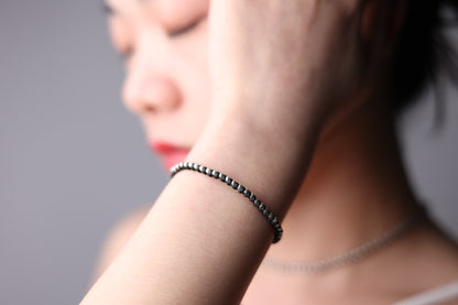 Handwoven Silver Set — close-up of matching bracelet worn on a wrist