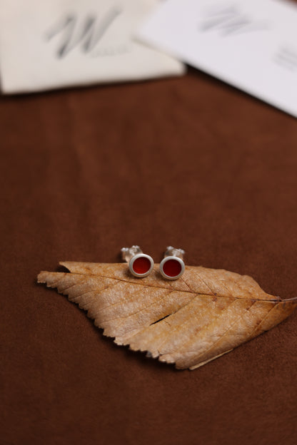 The B & R Agate Ear Stud — red ear studs on a dried leaf
