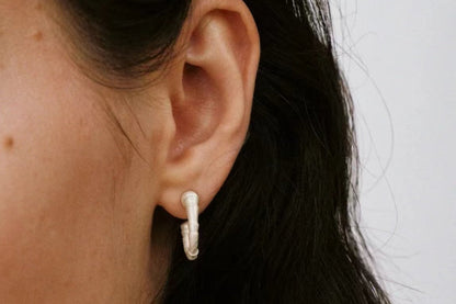 The Seashell-Ear Hoop — textured hoop worn on an ear, close-up