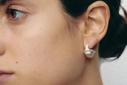 The Classic Agate-B & W — white stone earring worn on an ear