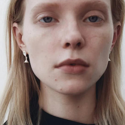 The Hourglass-Ear Stud — model wearing hourglass-shaped studs