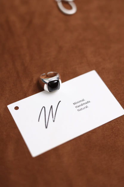 The Smoky Quartz Signet Ring — signet ring displayed above branded card