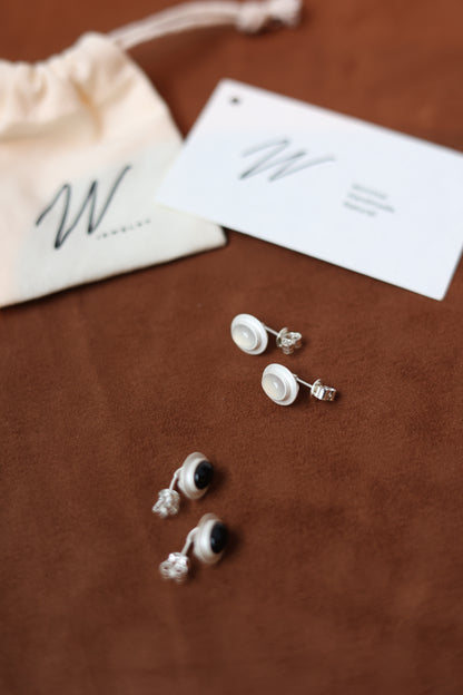 The Classic Agate-B & W — black and white stone earrings beside brand cards