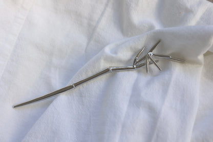 Bamboo Hair Pin — bamboo-shaped hair pin on pale fabric