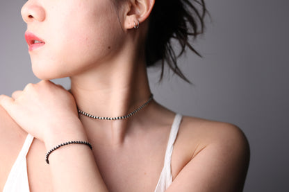 Handwoven Silver Set — model wearing necklace and matching bracelet