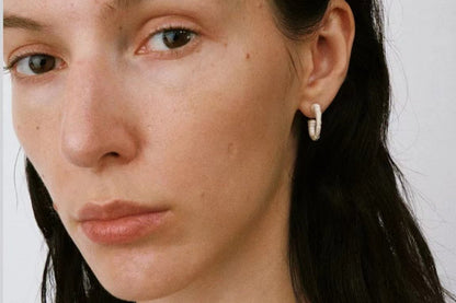 The Seashell-Ear Hoop — model wearing a silver-tone textured hoop