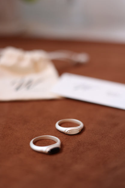 The B & W Onyx Ring — two oval rings beside branded pouch