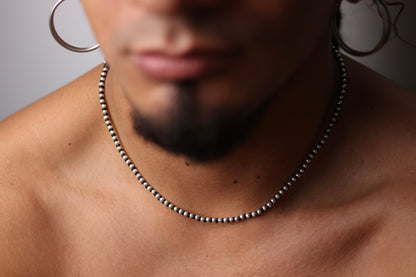Handwoven Silver Set — close-up of necklace worn around the neck