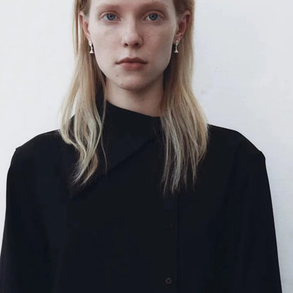 The Hourglass-Ear Stud — front view of model wearing hourglass studs with black top